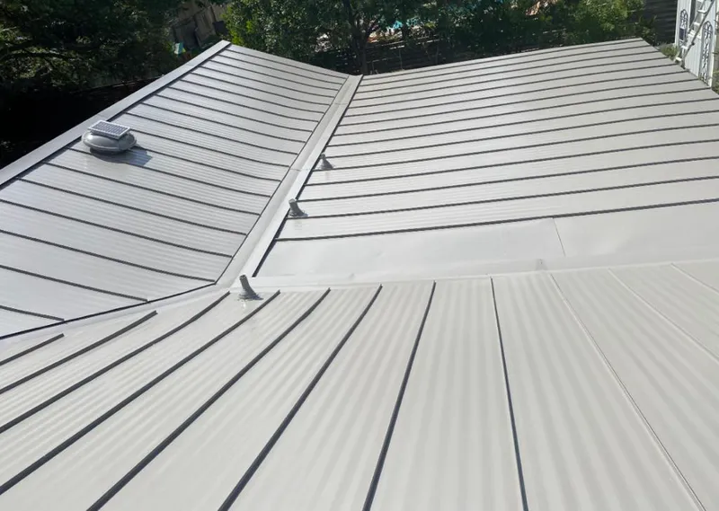 Solar attic fan installed on a metal roof for Roof Ventilation in Earlimart